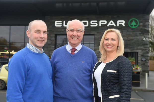 Eric (centre), alongside his son, Gary Reid and daughter, Joanne Gourley outside their retailing business, Fruitfield Service Station